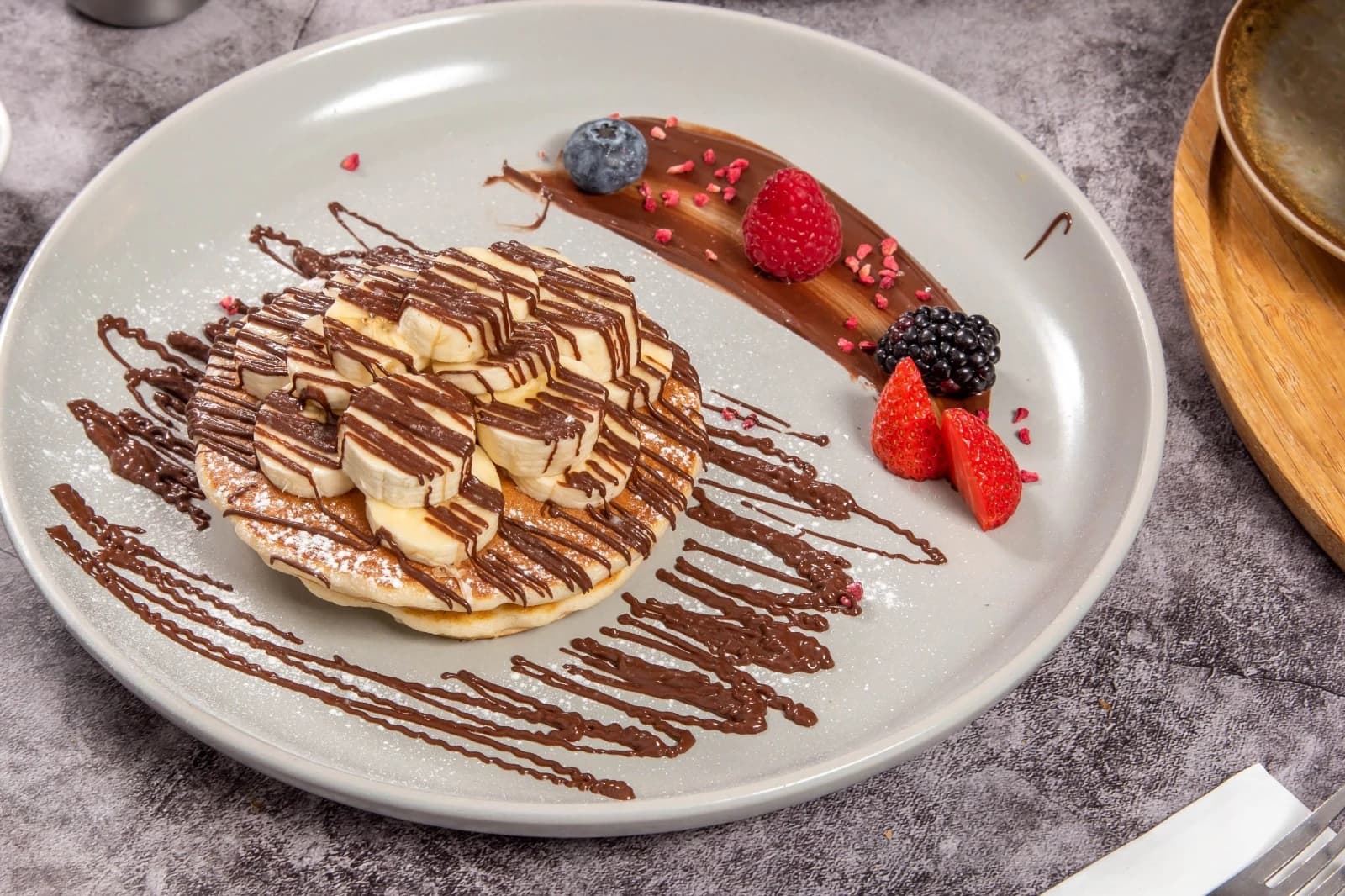 Fresh banana and Nutella pancakes with berries at Mortimer Bistro